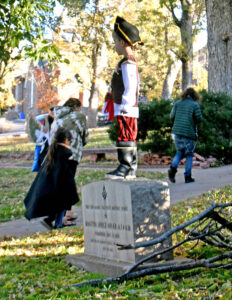 A small pirate surveys the view from the historical marker on the library lawn.