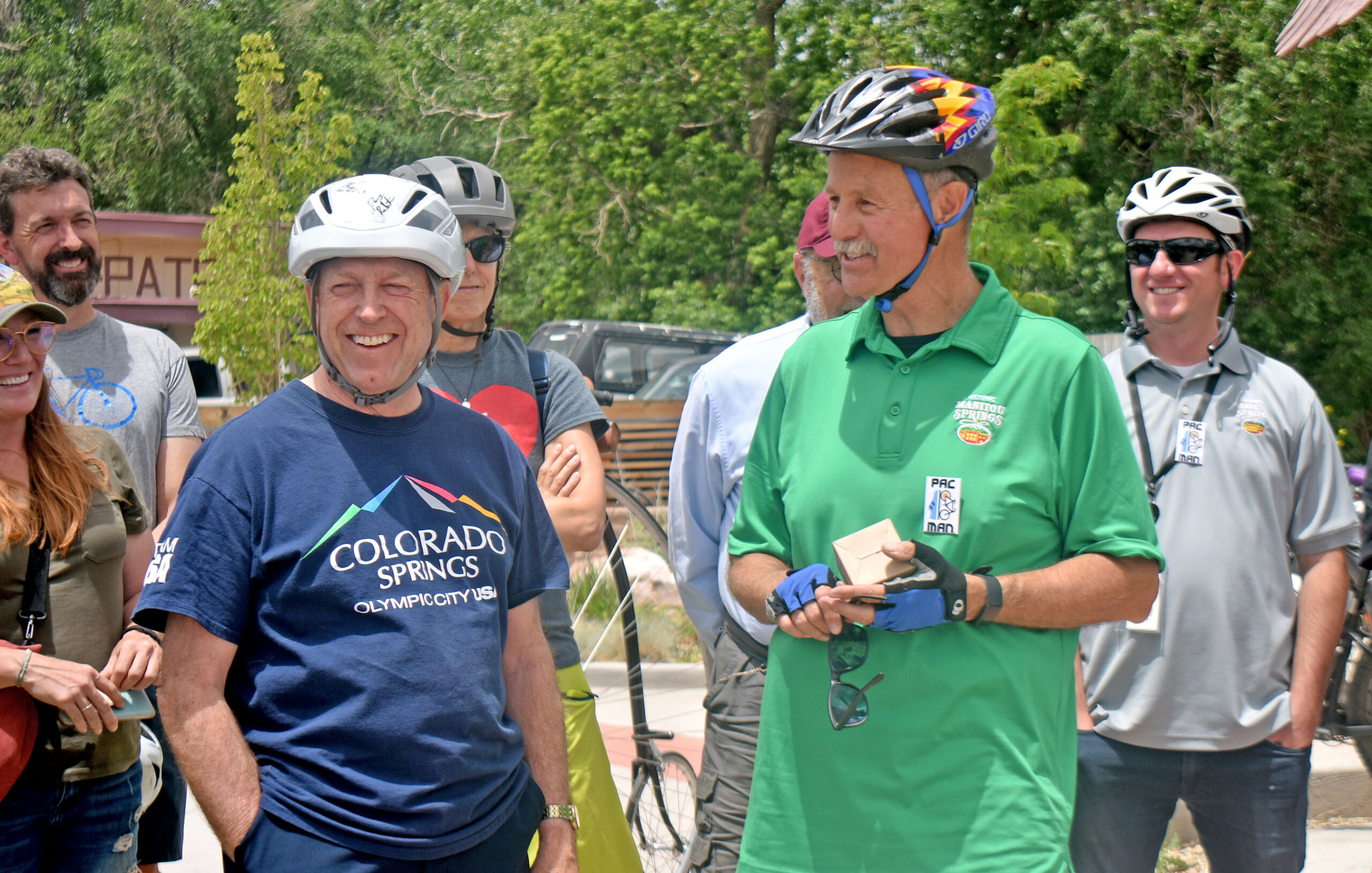 Bulletin file photo. Colorado Springs Mayor John Suthers, left, and Manitou Mayor John Graham exchange gifts and laughs during the June 24 Mayors Bike Ride, an annual event that PaC-Man organizes.