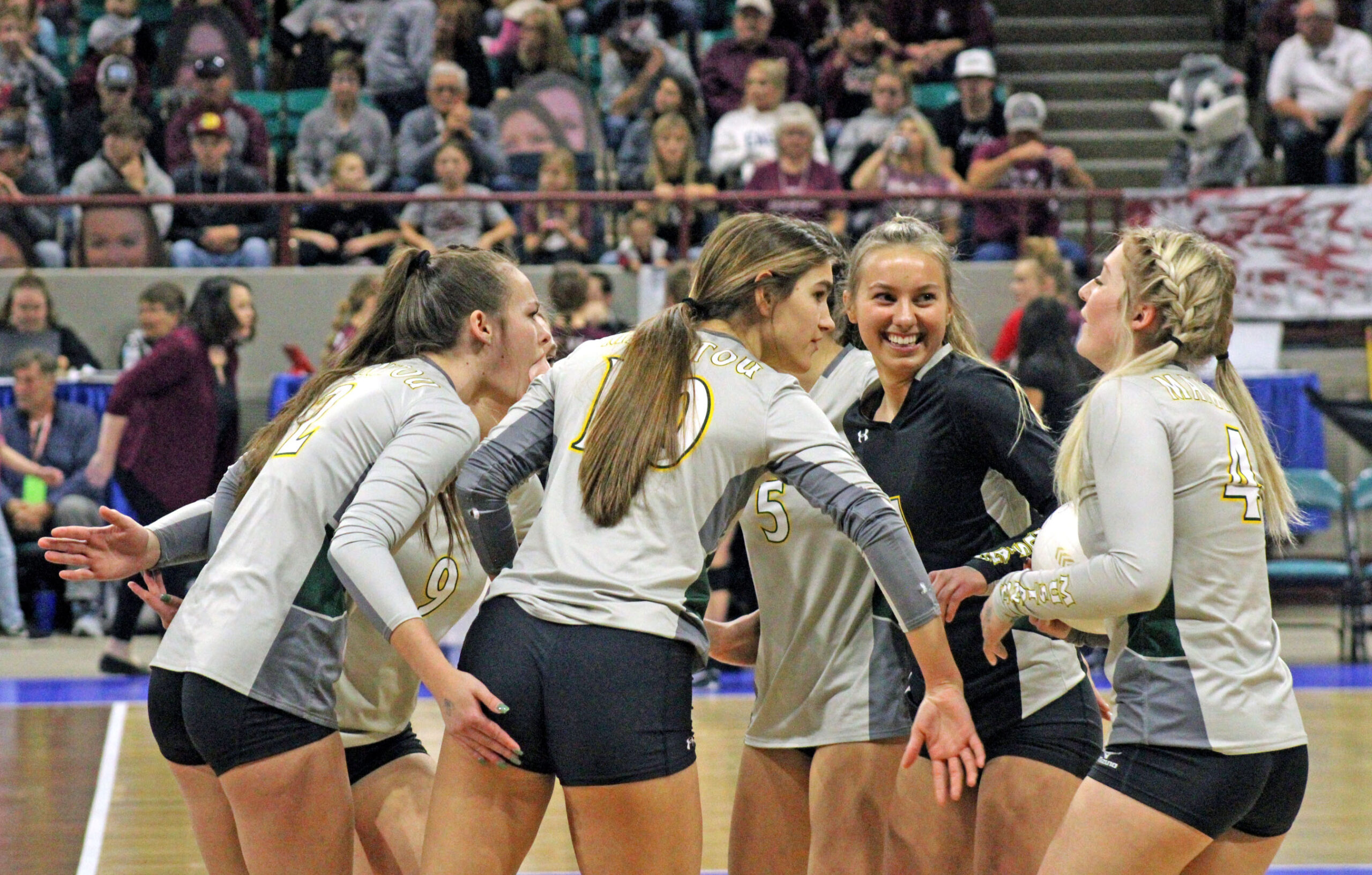 Photo by Daniel Mohrmann. The Manitou Springs volleyball team celebrates a point during its match against Platte Valley at the 3A State Volleyball Tournament.