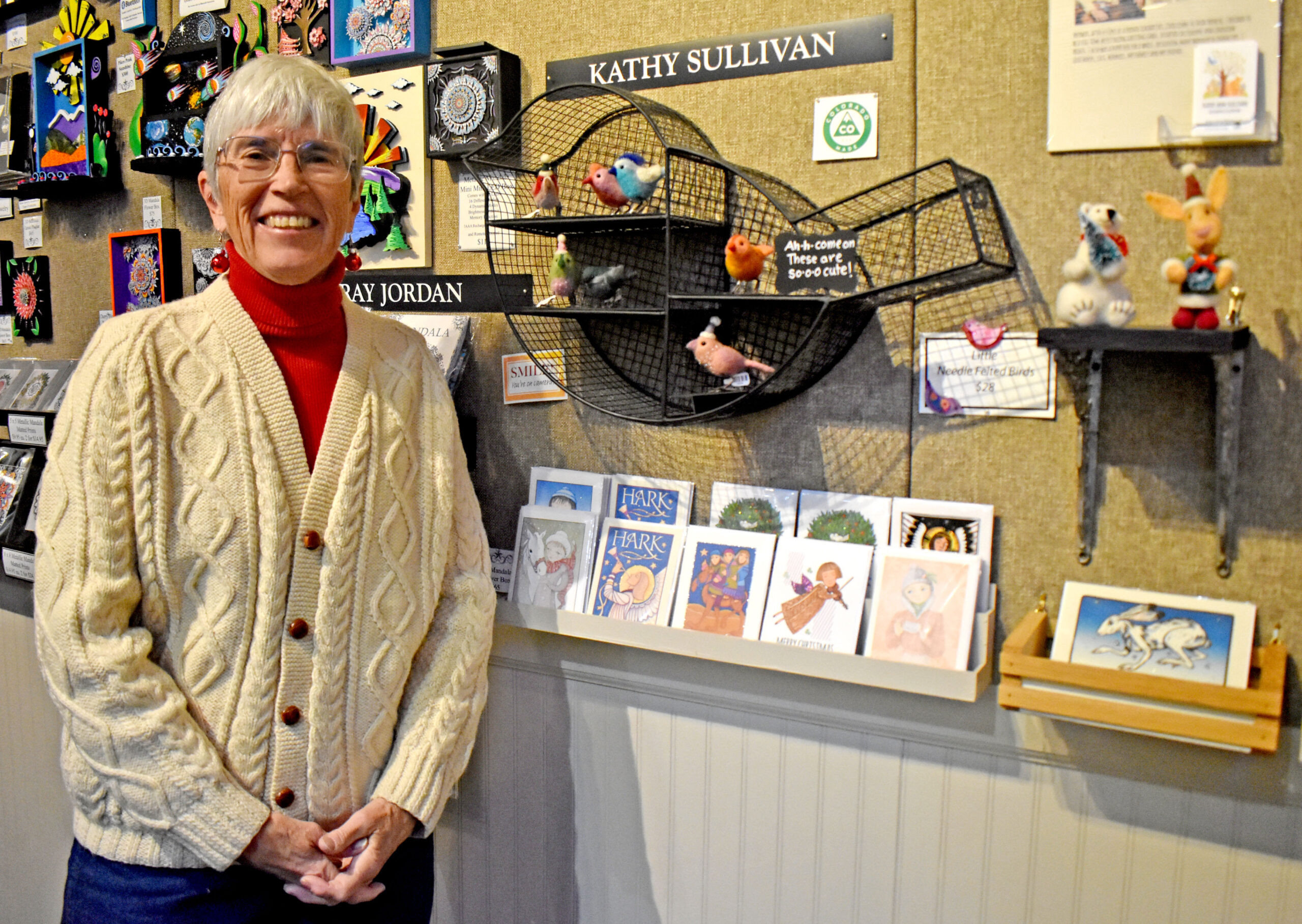 Photo by Rhonda Van Pelt. Kathy Sullivan stands next to her display at Commonwheel Artists Co-op.