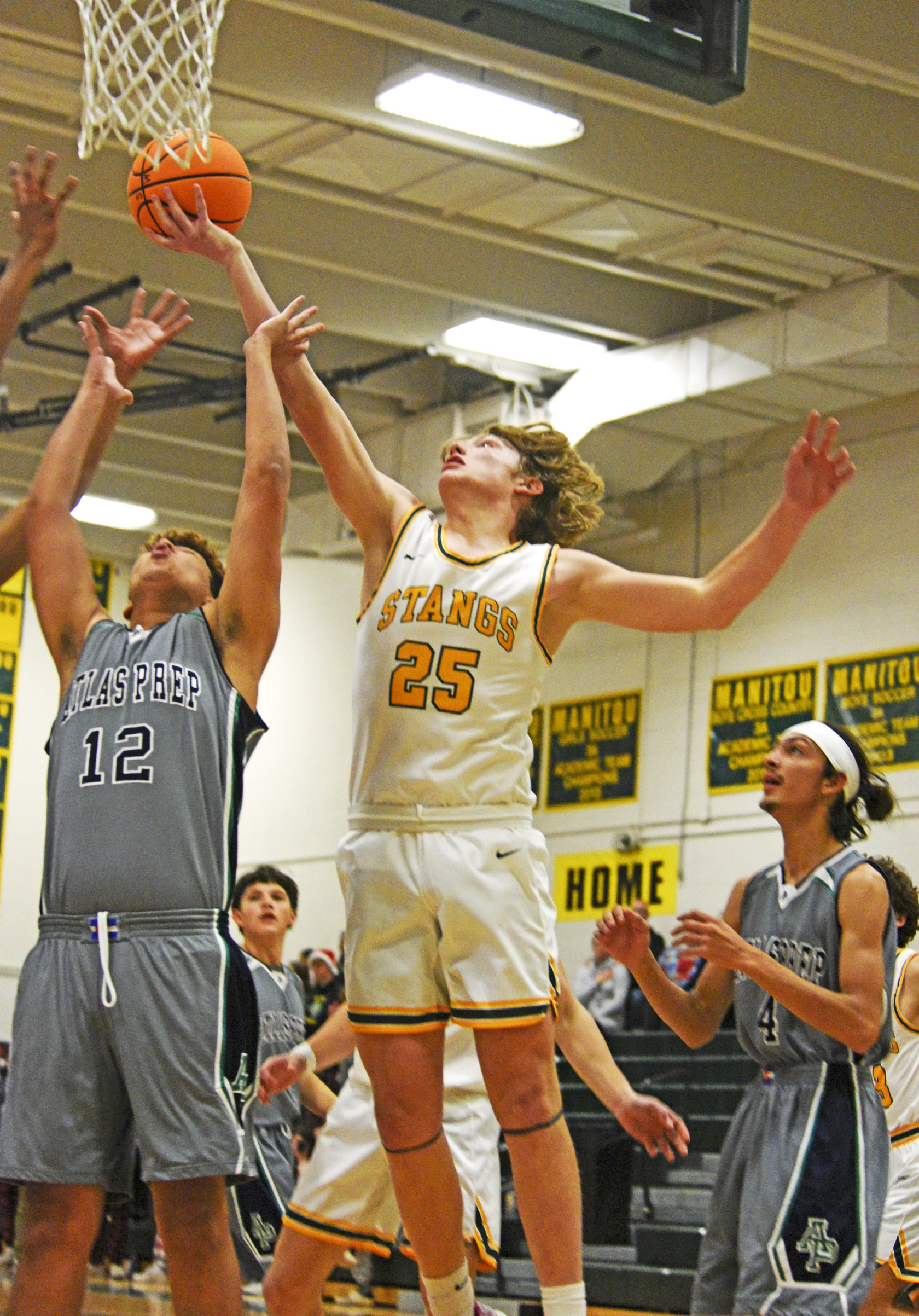 Photo by Bryan Oller. Nate Gentzel outreaches an Atlas Prep player during their Dec. 16 game.